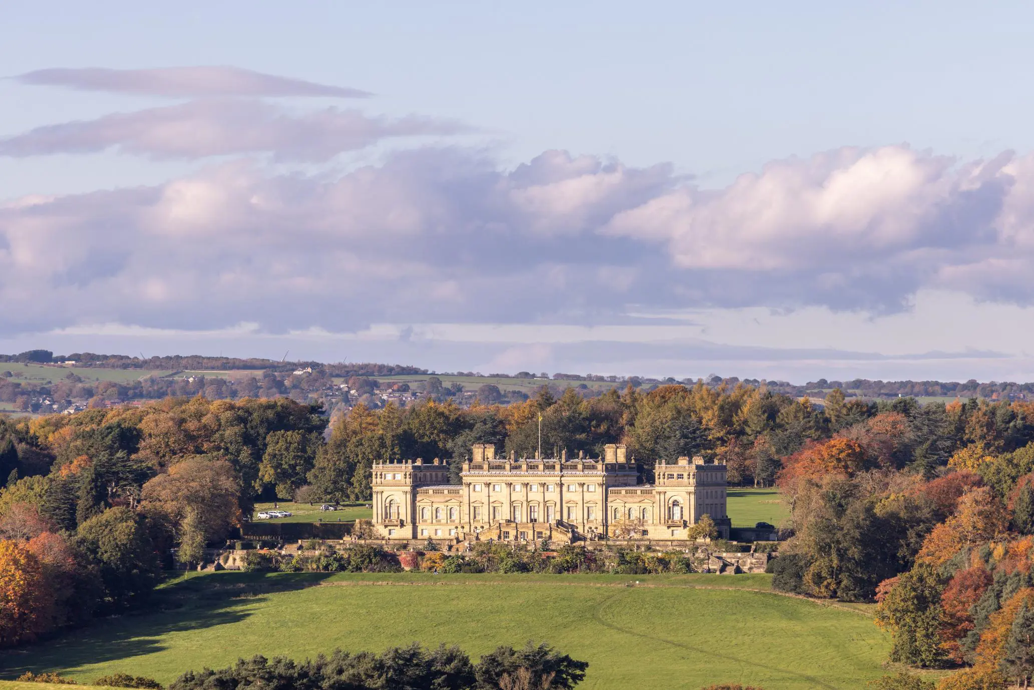 Harewood House, a grand stately home set among autumnal trees and rolling Yorkshire countryside