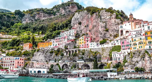 The Amalfi Coast View From Water, showing the buildings along the rock in the cliff