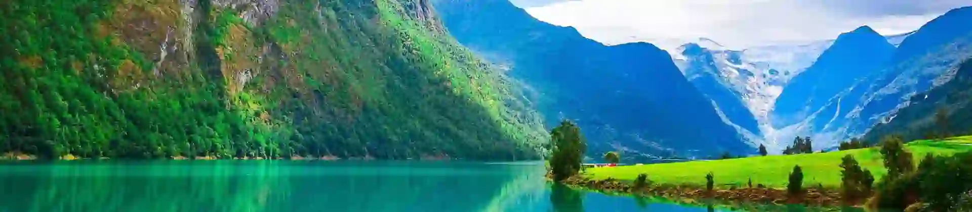 A scenic view of Sognefjord, Norway, featuring deep blue fjord waters surrounded by steep, green mountains