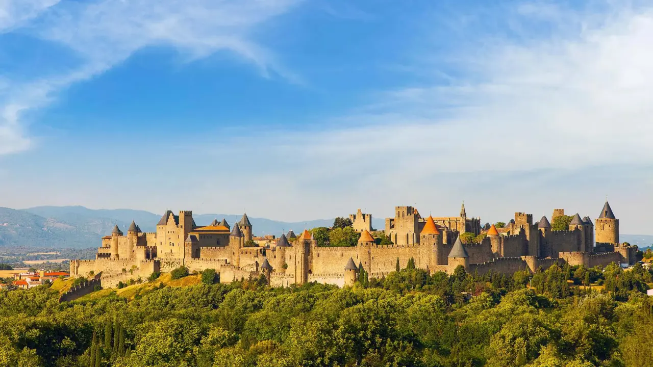 Wide view of the medieval Cité de Carcassonne fortress in France, surrounded by its historic stone walls and towers