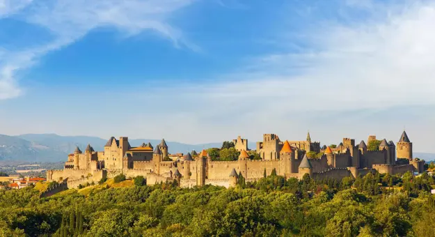 Wide view of the medieval Cité de Carcassonne fortress in France, surrounded by its historic stone walls and towers
