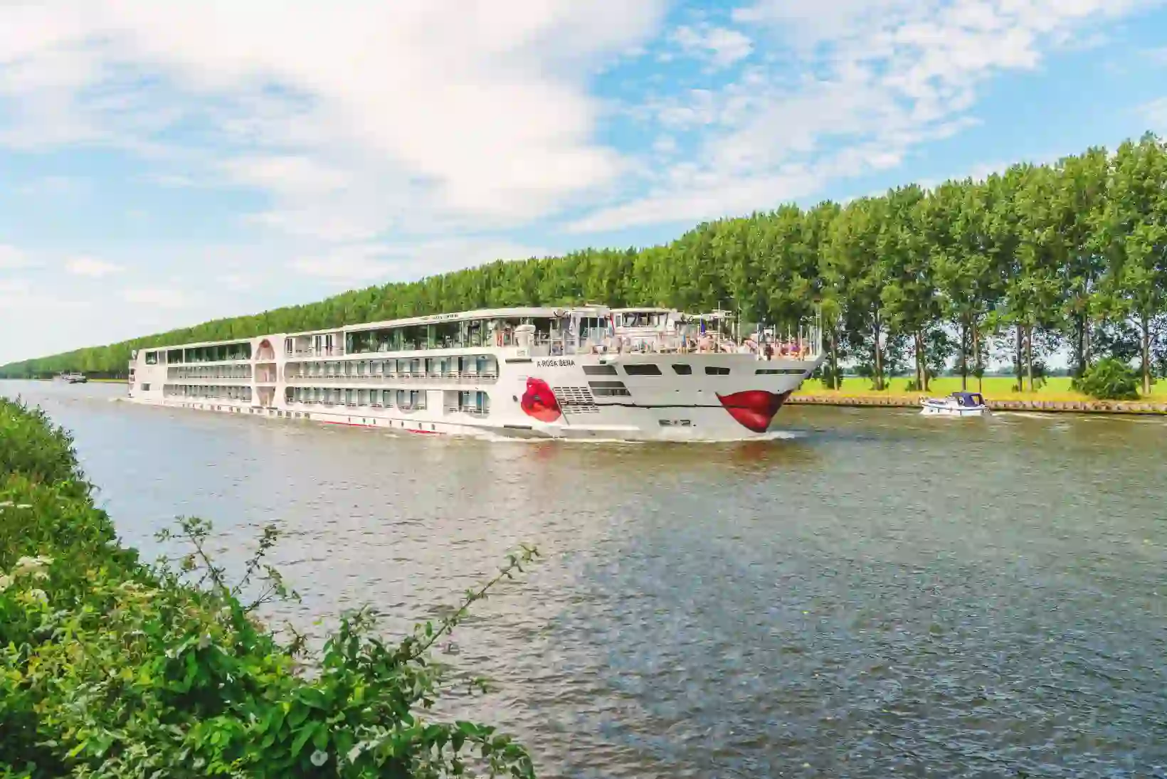 The A-ROSA SENA river cruise ship on a calm river, showcasing its modern exterior against a scenic backdrop