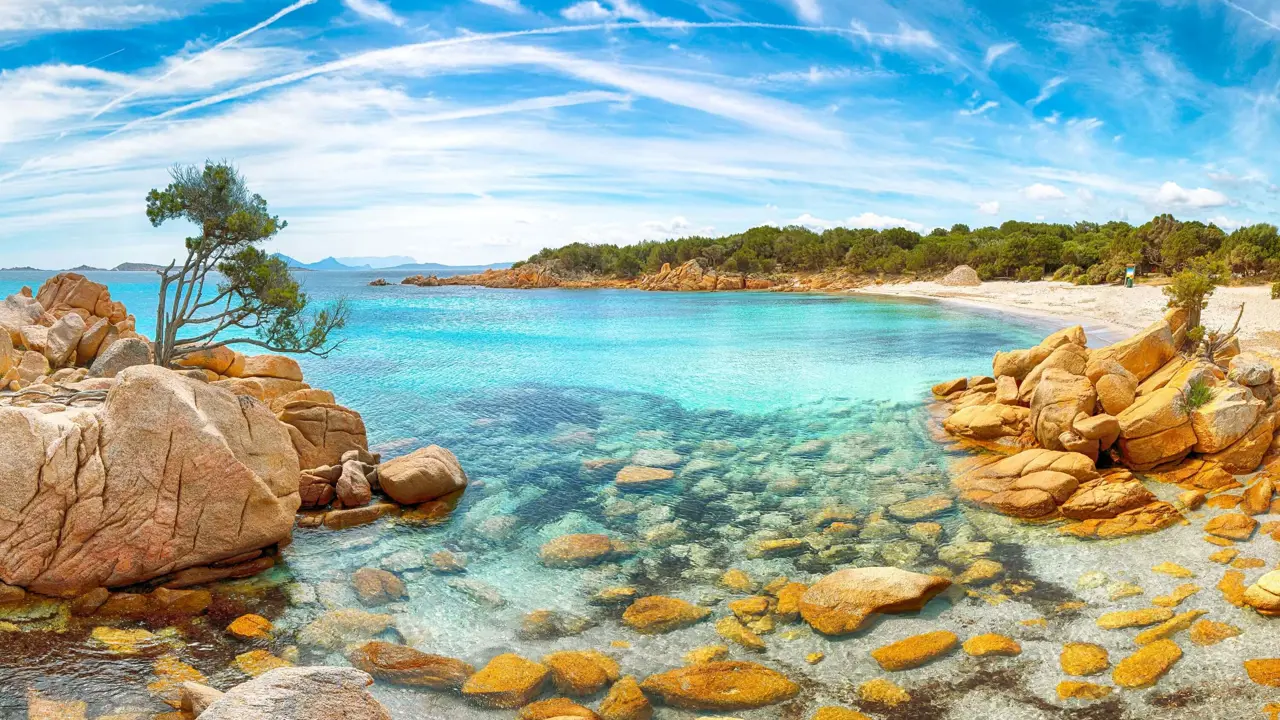 Costa Smeralda seascape, Sardinia, showing the clear blue water and rocks in the forefront