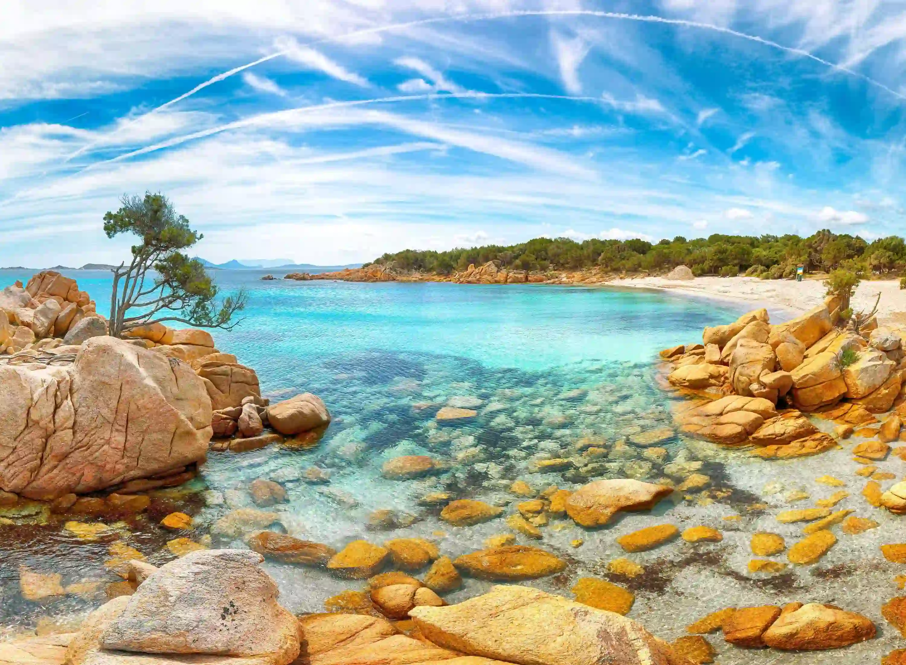 Costa Smeralda seascape, Sardinia, showing the clear blue water and rocks in the forefront