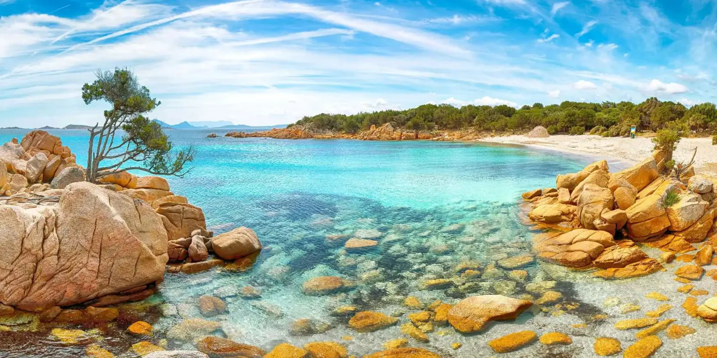 Costa Smeralda seascape in Sardinia, showing the clear blue water and rocks in the forefront
