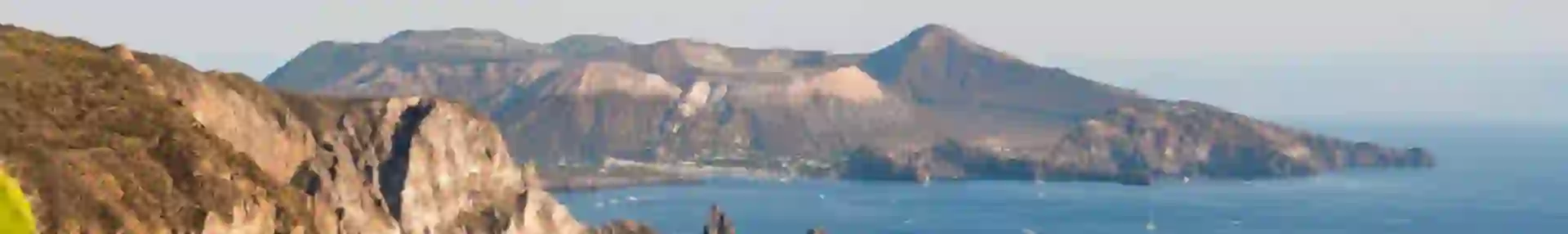 View of Quattrocchi with boats on the water and cacti in the forefront