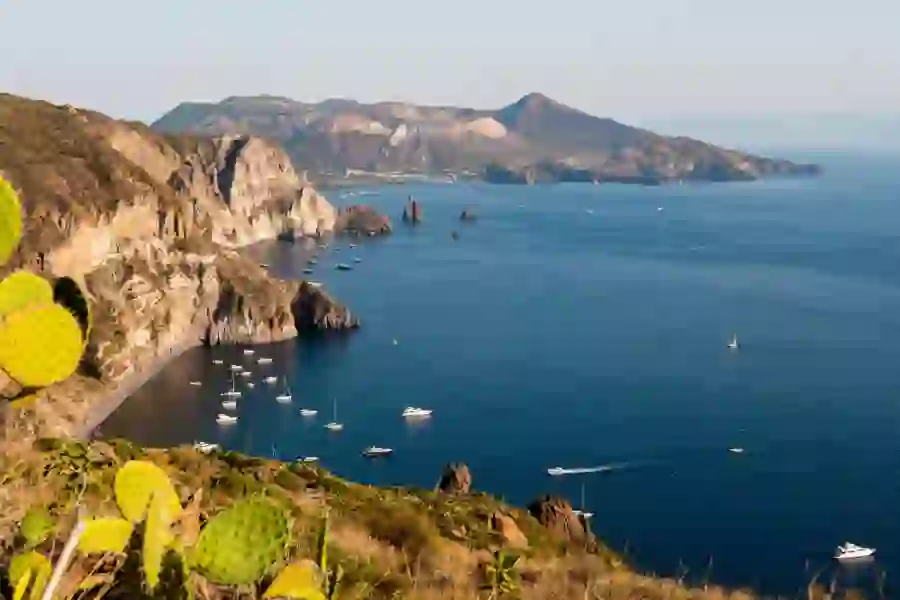 View of Quattrocchi with boats on the water and cacti in the forefront