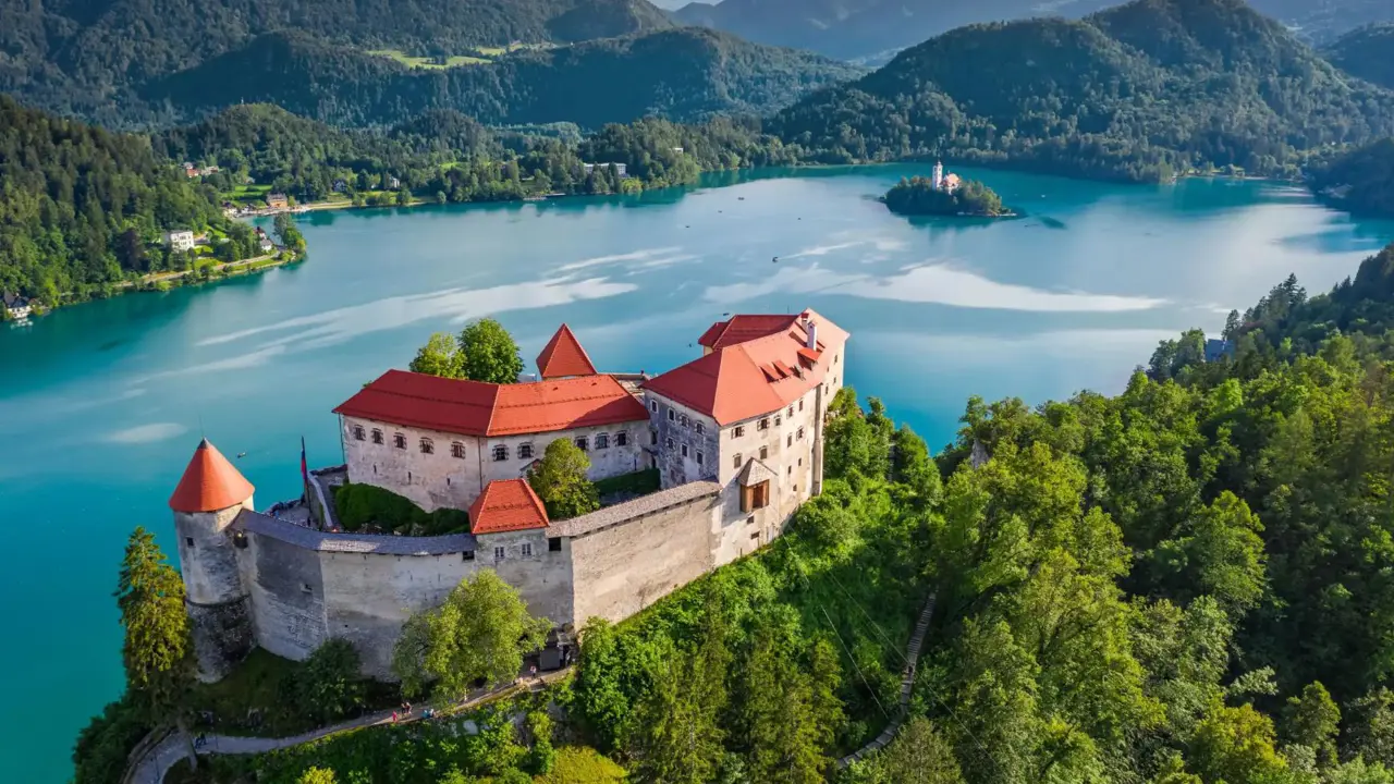 Bled Castle in Slovenia overlooking Lake Bled, with a small island church and surrounding forested mountains