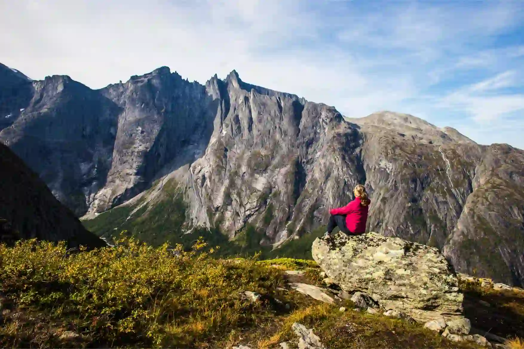 Solo woman traveller enjoying the views of the famous Troll Wall, Fjord Norway