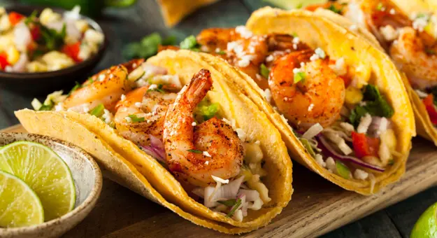 Homemade spicy shrimp tacos with coleslaw and salsa