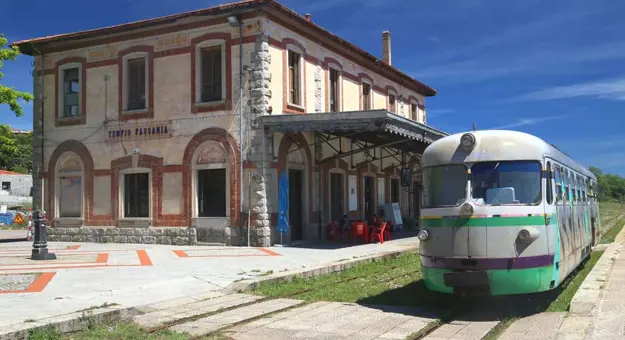 Trenino Verde Train moving along tracks in Sardinia