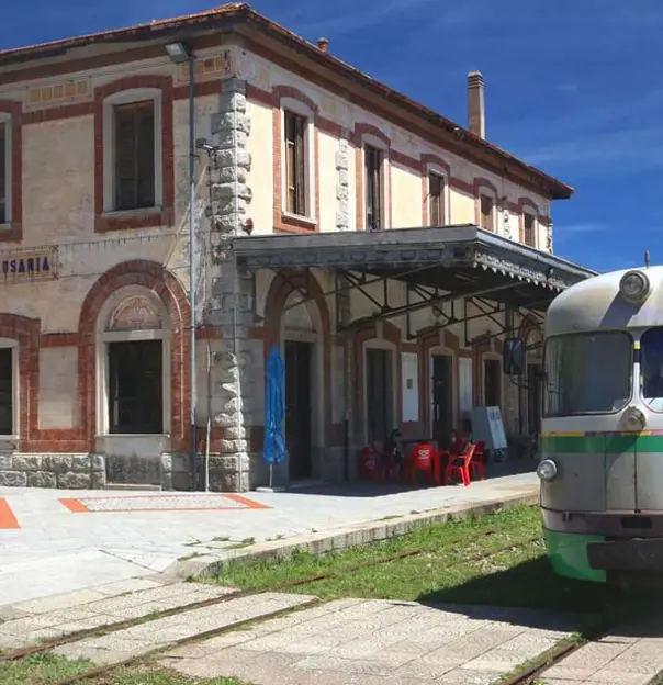 Trenino Verde Train moving along tracks in Sardinia