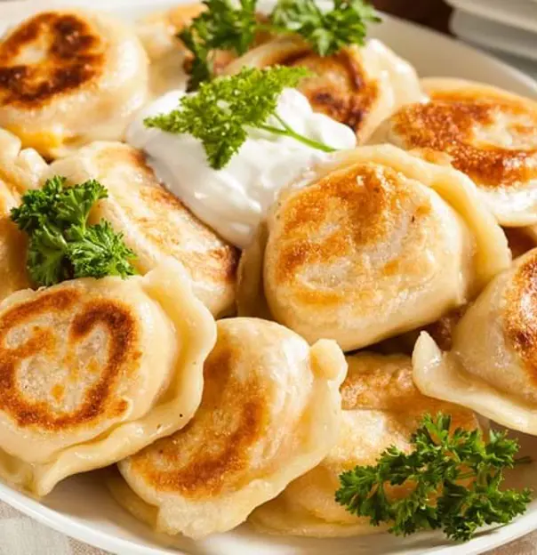 Gettyimages 486978329 Homemade Polish Pierogis With Sour Cream