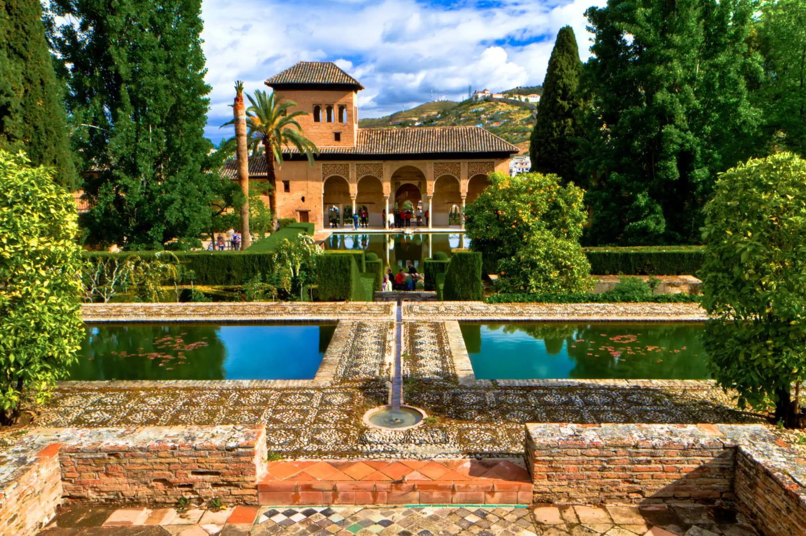 Ornate gardens and reflecting pools at the Alhambra Palace in Granada