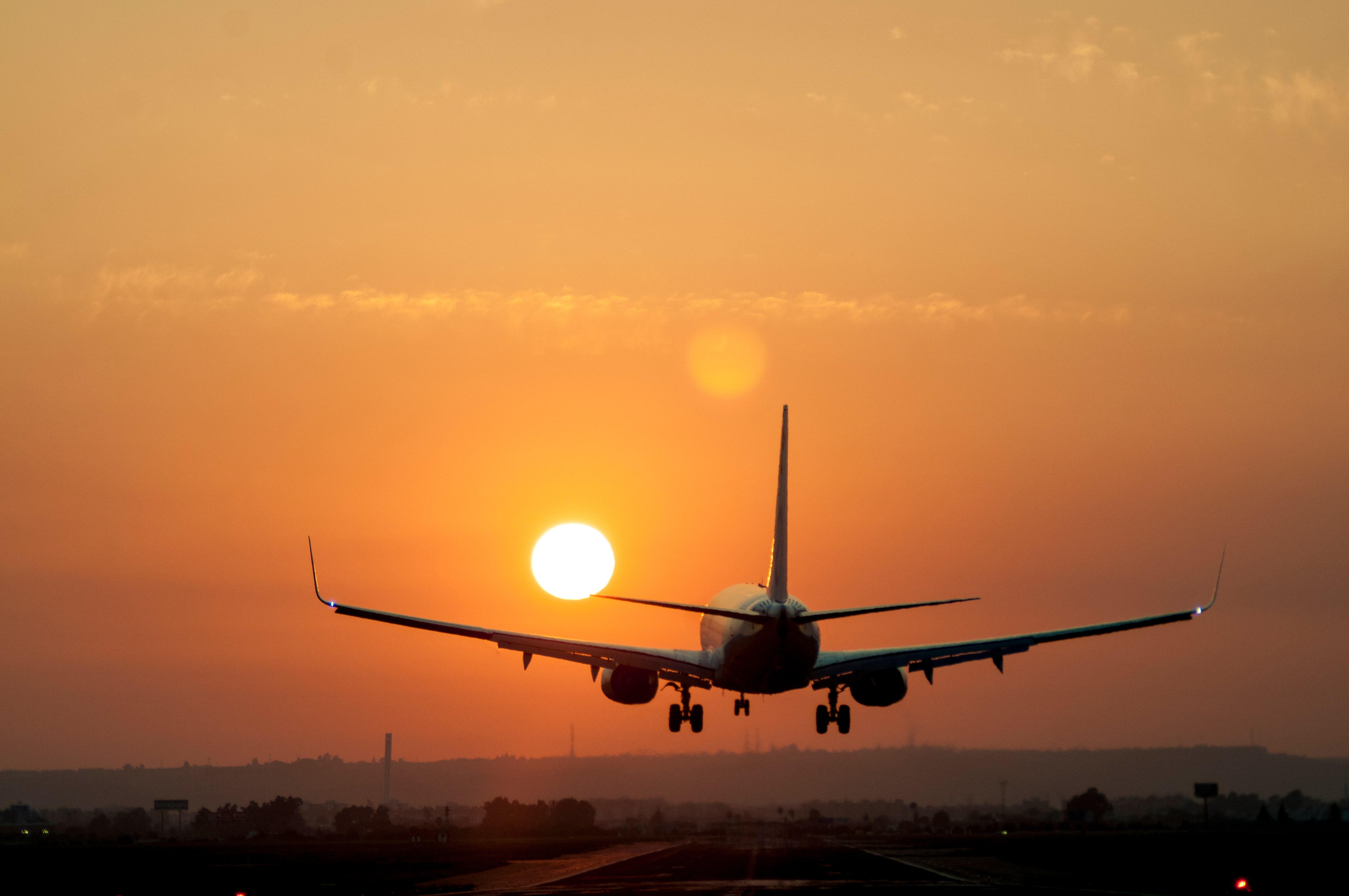 Airplane landing at sunset 