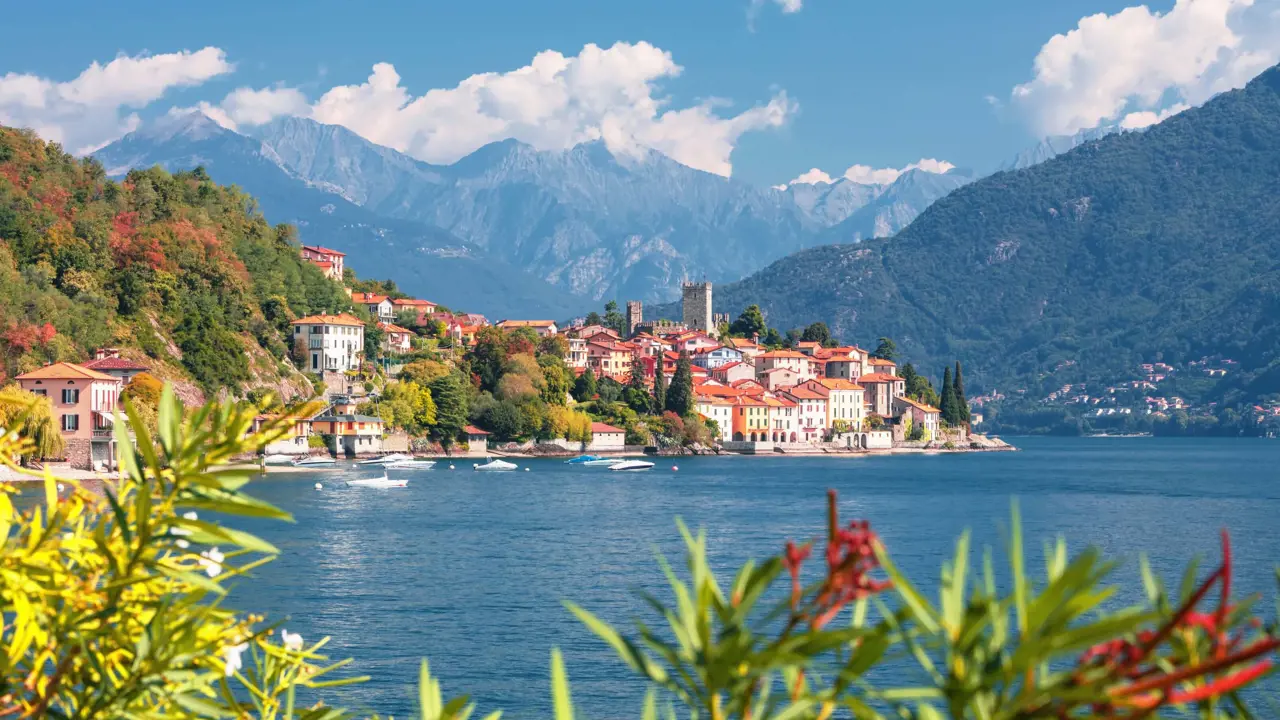 View of houses on the waterfront in Malcesine, Lake Garda with mountains in the distance