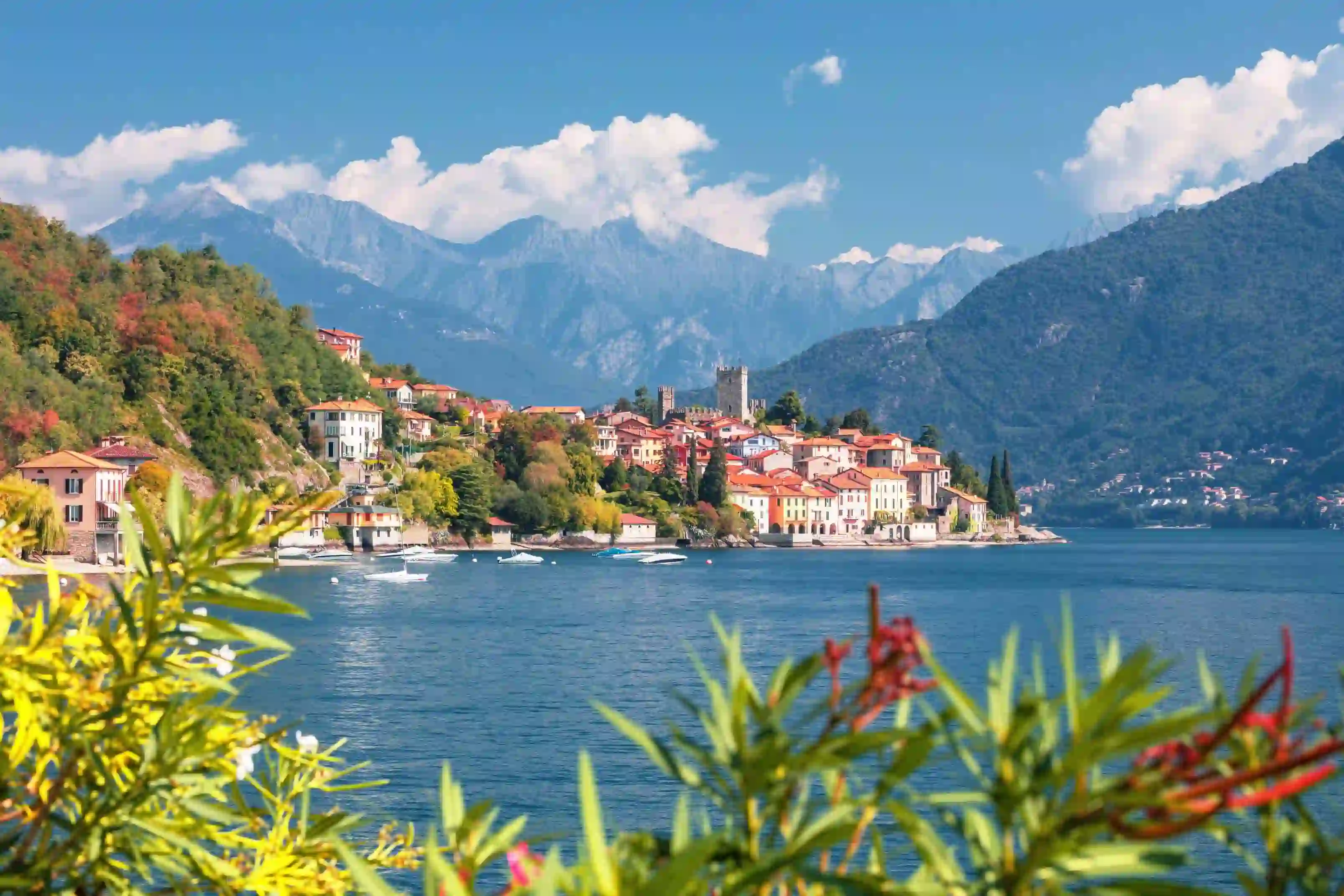 View of houses on the waterfront in Malcesine, Lake Garda with mountains in the distance