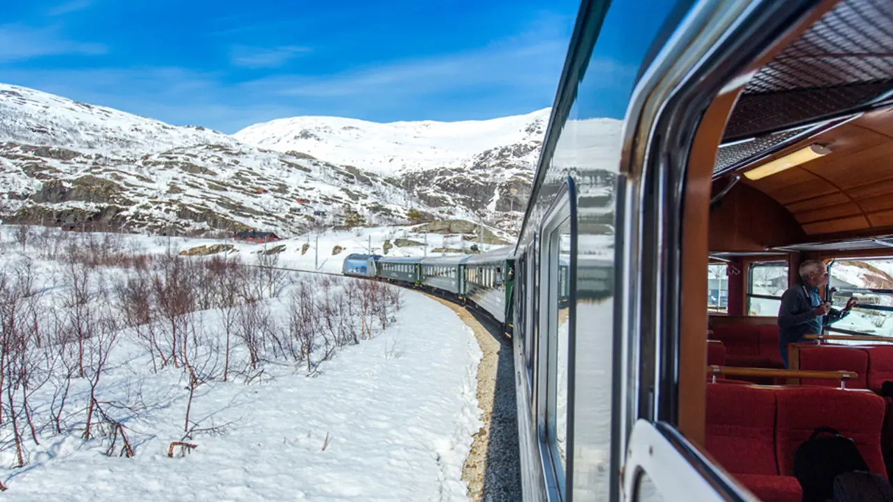 Train going through snowy land in Norway