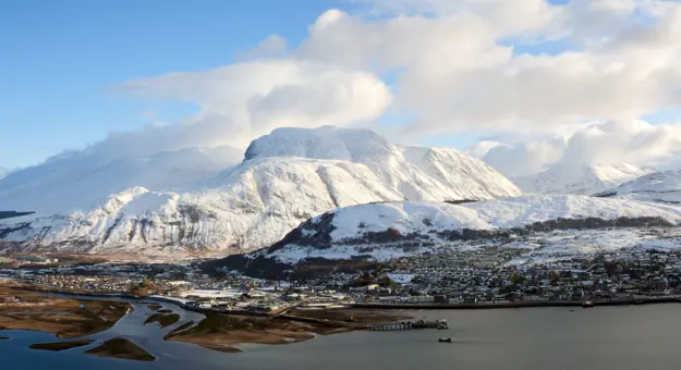View of Fort William village with snowy Ben Nevis mountain behind