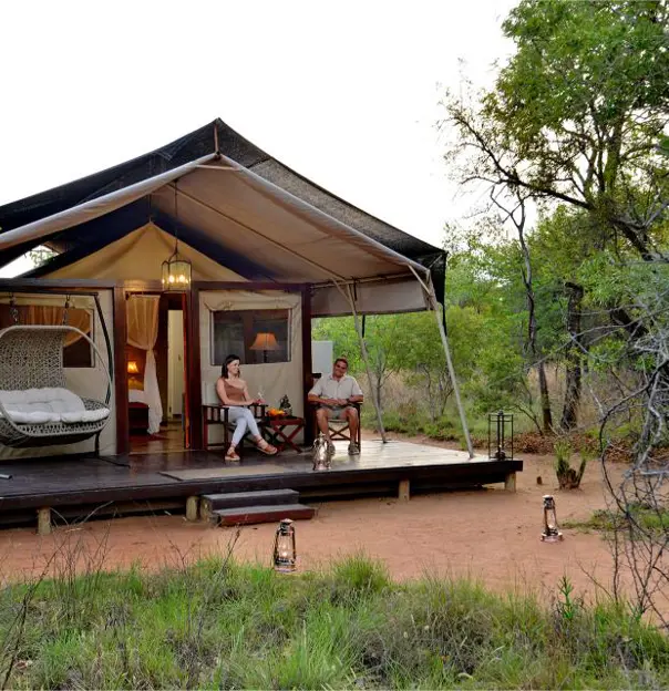 Safari Plains couple sitting outside their tent 