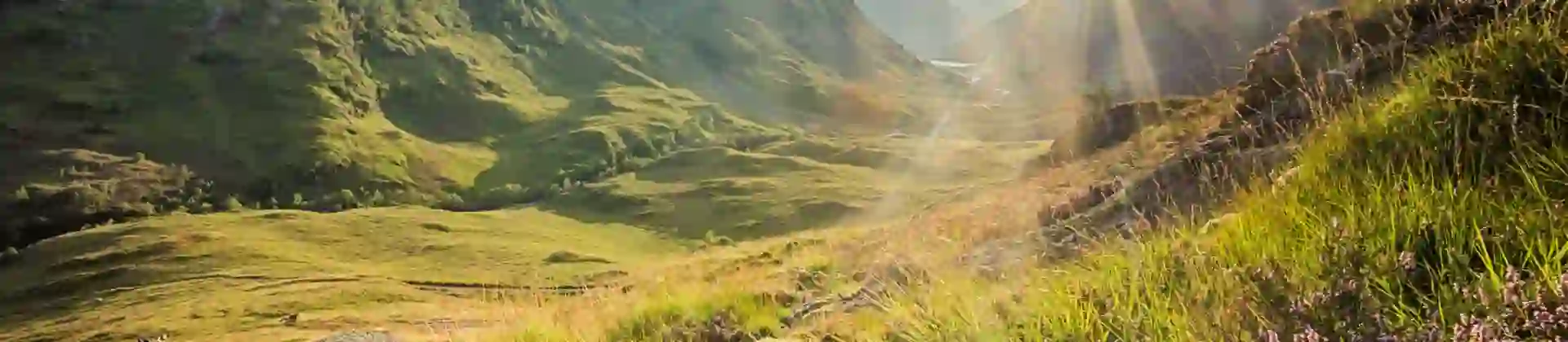 View of the Scottish Highlands with sunshine coming through behind them