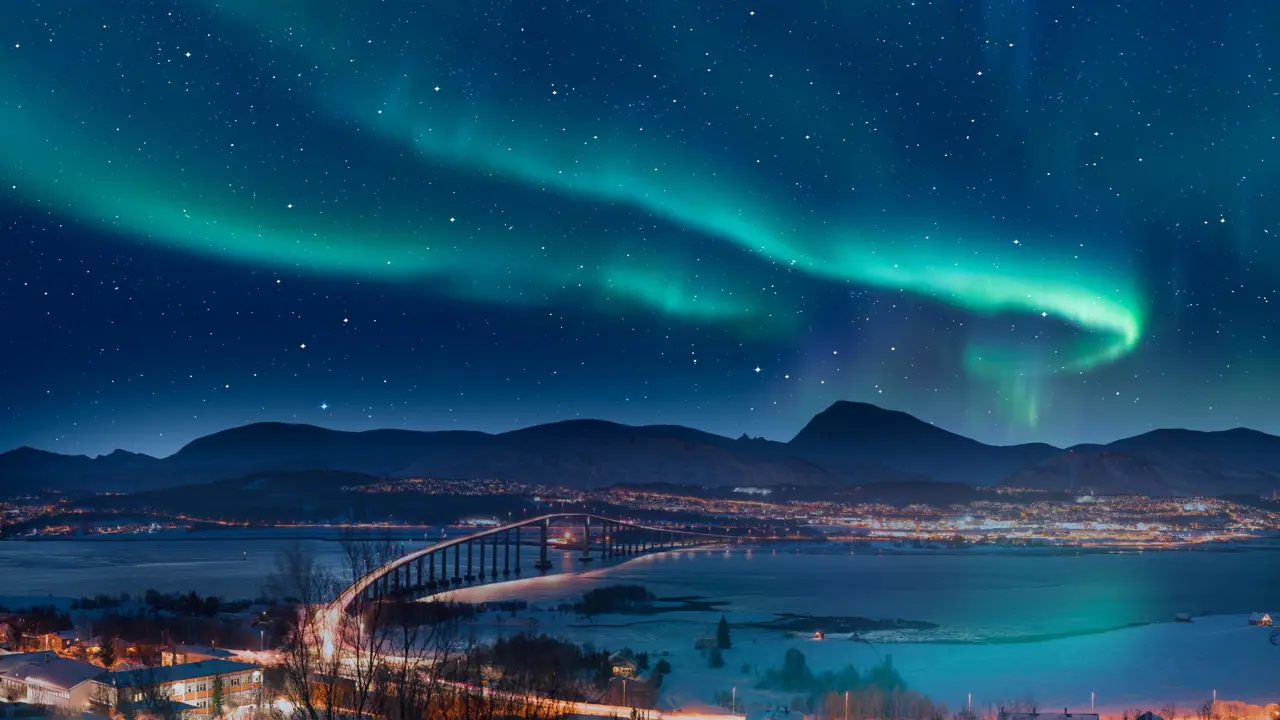 Aurora borealis or Northern lights in the sky over Tromso with Sandnessundet Bridge - Tromso, Norway