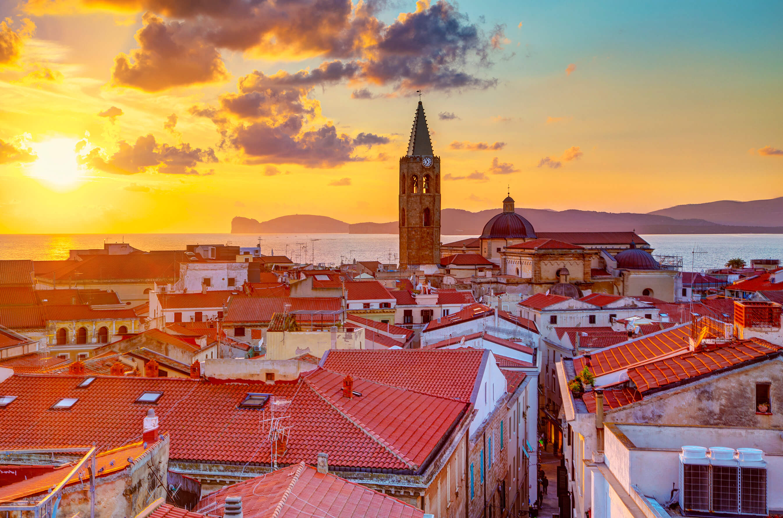 View of Alghero with the sea in the background at sunset