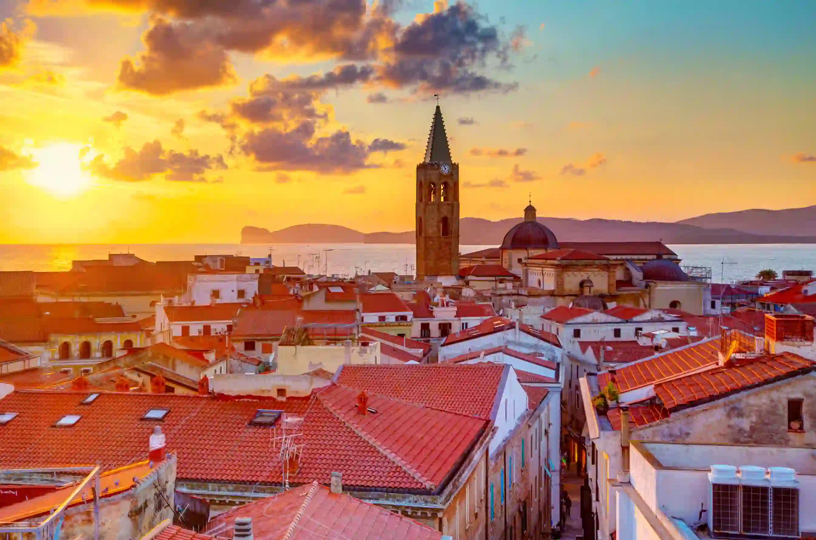 View of Alghero with the sea in the background at sunset