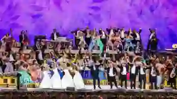 André Rieu performing in Maastricht alongside a stage of musicians and performers