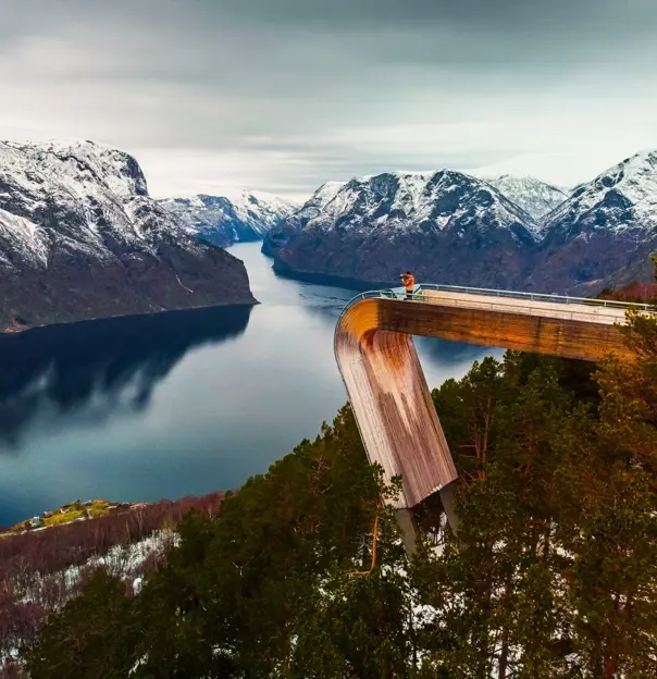 An image man standing on Stegastein Viewing Platform overlooking the fjord