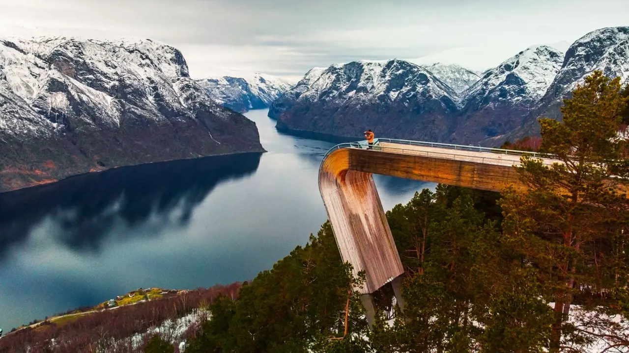 An image man standing on Stegastein Viewing Platform overlooking the fjord