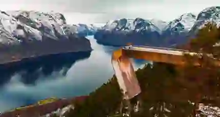 An image man standing on Stegastein Viewing Platform overlooking the fjord