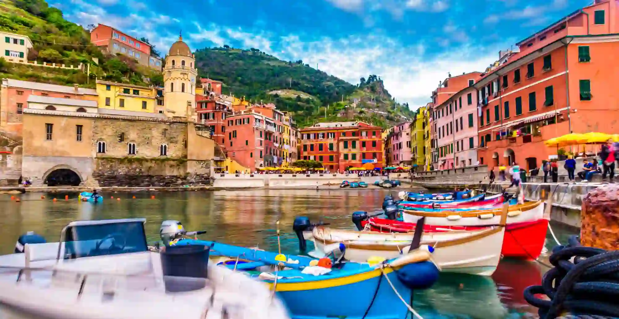 A row of canoes on the water infront of the town of Clinque Terre in Liguria, Italy