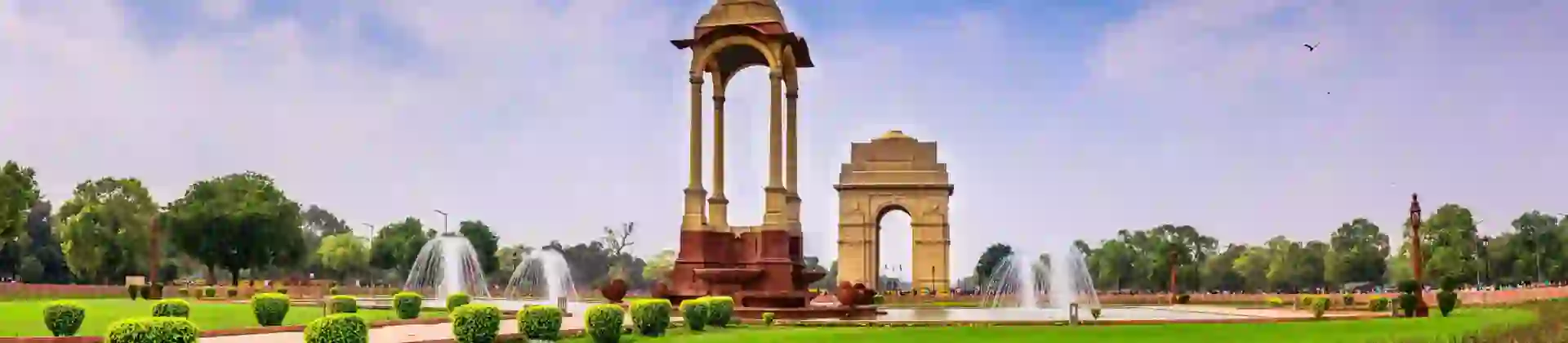 A view of India Gate and surrounding fountains and gardens in Delhi, India