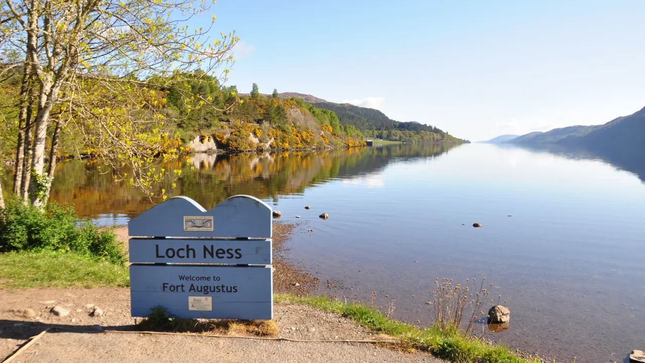  Loch Ness sign in front of the water and mountains 