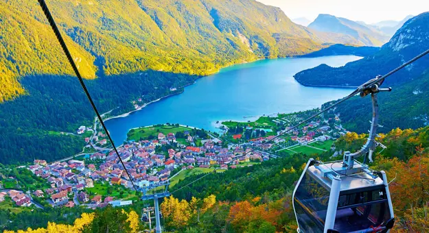 High angle view of Molveno Italy with Lake Molveno and cable car in the forefront