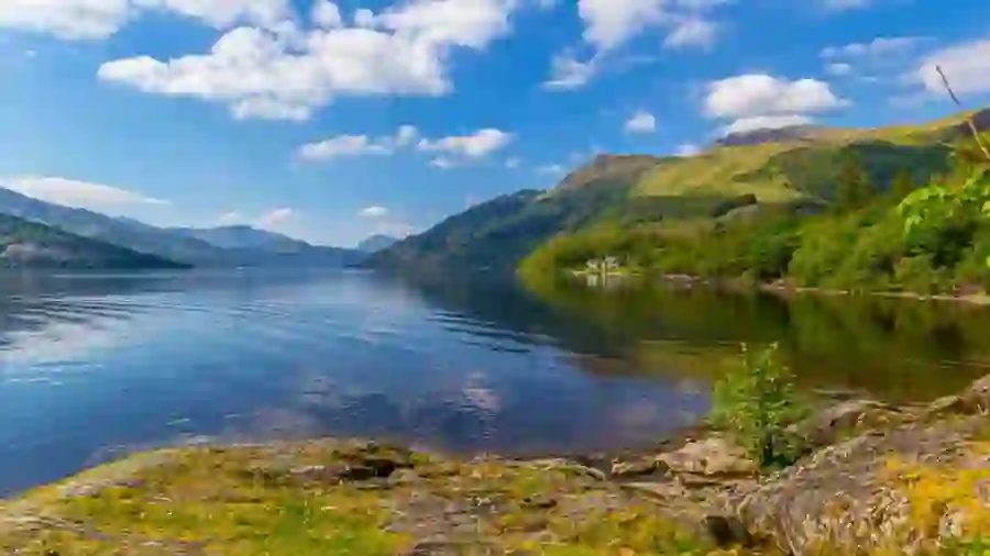 Loch surrounded by mountains in daylight