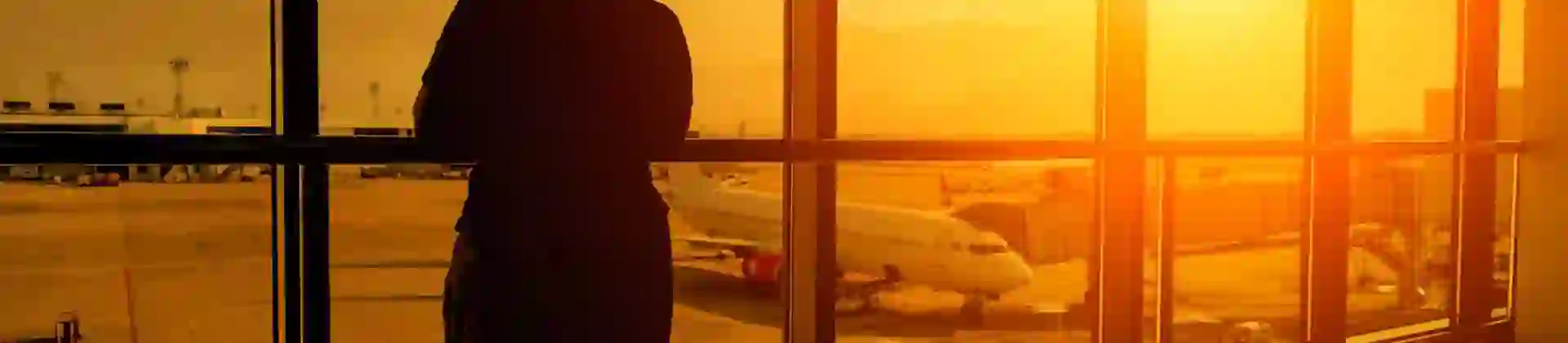 Person looking out the window in an airport