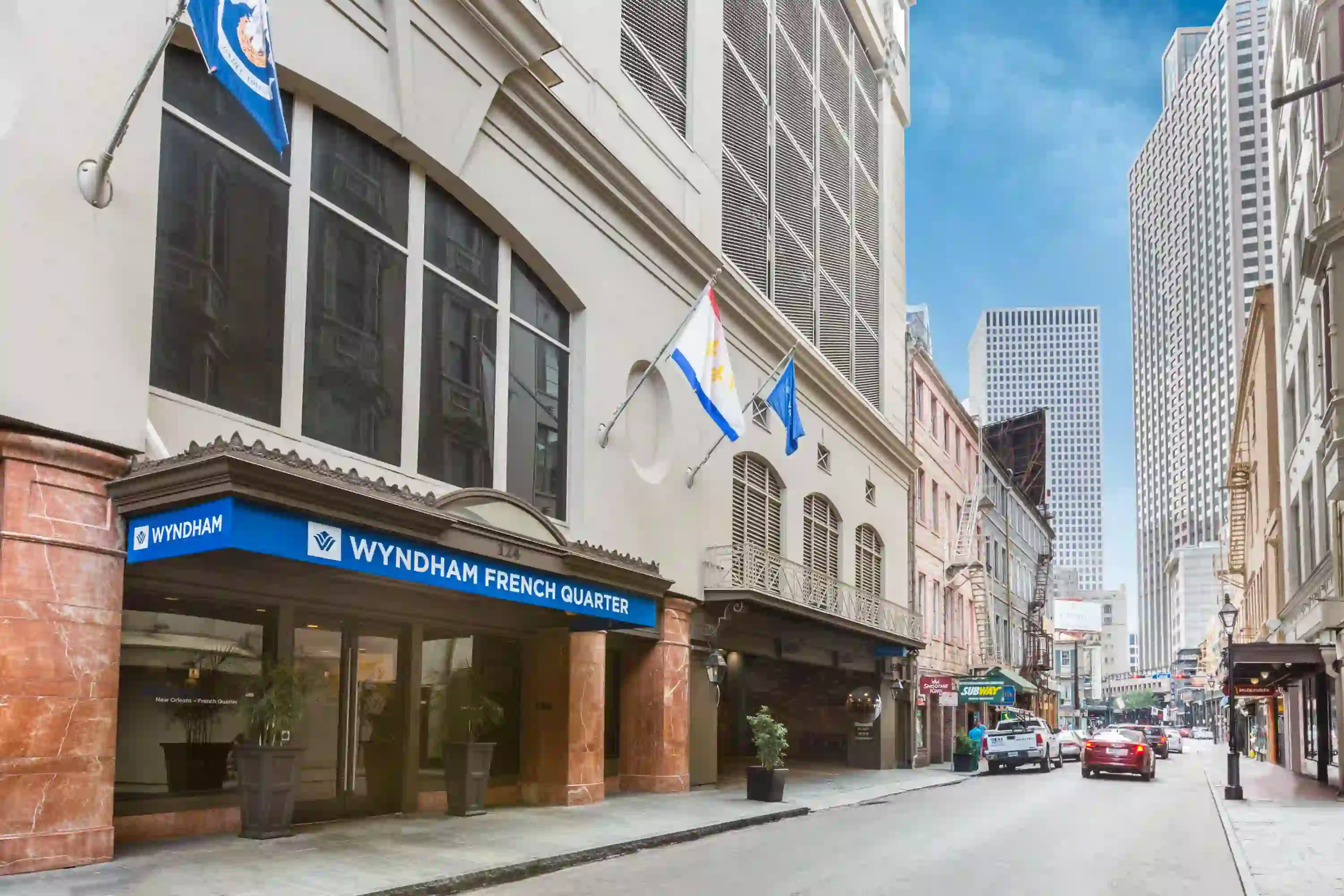 Exterior of Wyndham French Quarter in New Orleans, featuring large windows overlooking the street