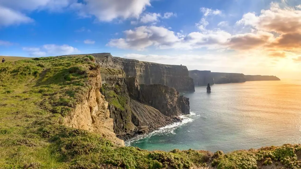 Cliffs of Moher, view of the sea on the right and rassy land in the left forefront