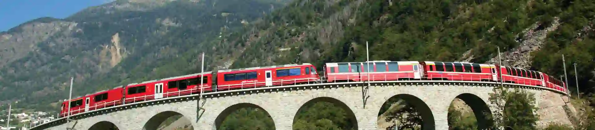 The Bernina Express going across Brusio Spiral Viaduct, Switzerland
