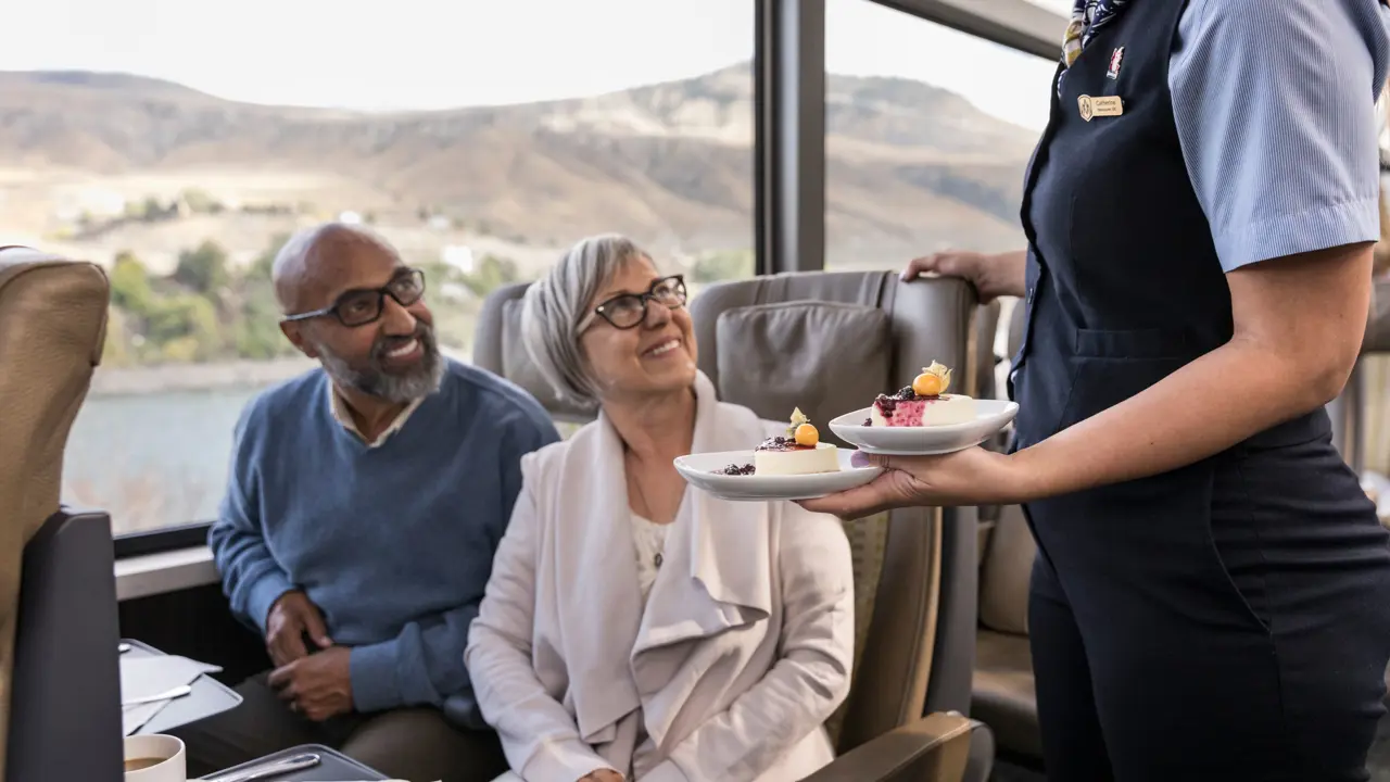 Couple Being Served On Train Through Canadian Rockies