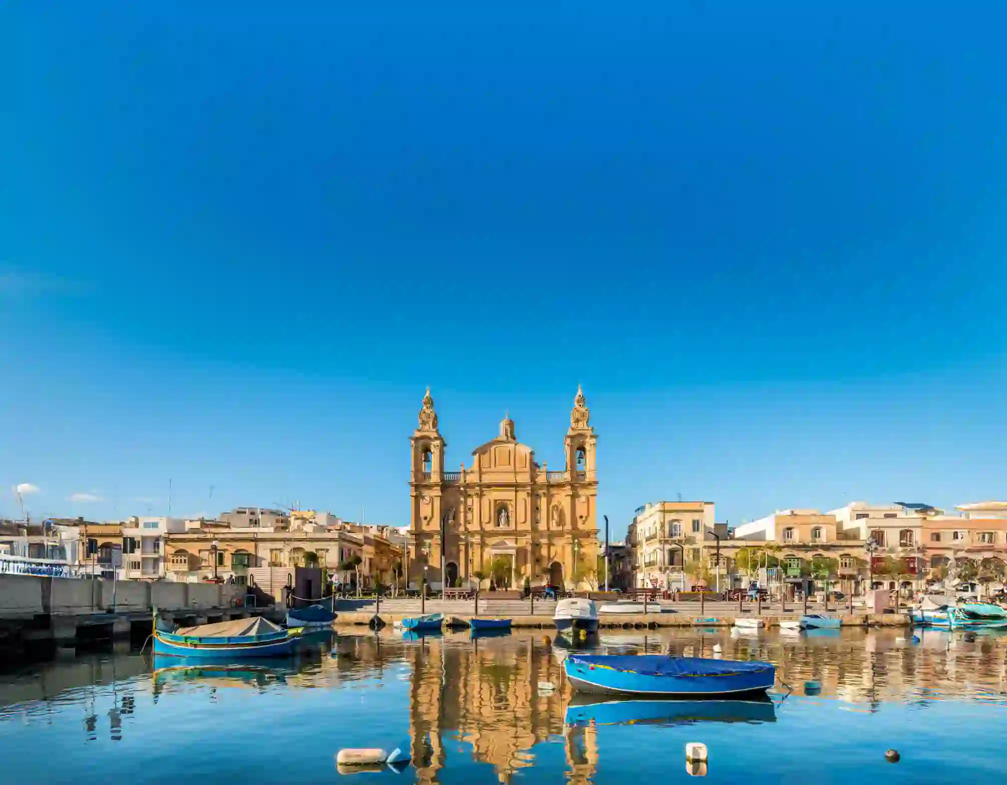 Marsamxett Harbour in Valletta, Malta, with the prominent Parish Church of Our Lady of Mount Carmel in Valletta visible across the water
