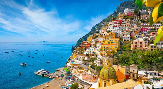 Colourful cliffside village of Positano on the Amalfi Coast, Italy, with pastel-coloured houses cascading down steep hills towards the sparkling blue Mediterranean Sea