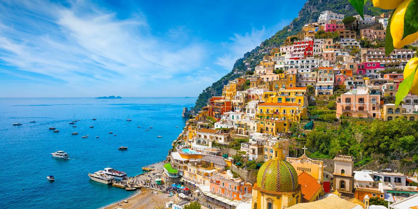 Colourful cliffside village of Positano on the Amalfi Coast, Italy, with pastel-coloured houses cascading down steep hills towards the sparkling blue Mediterranean Sea