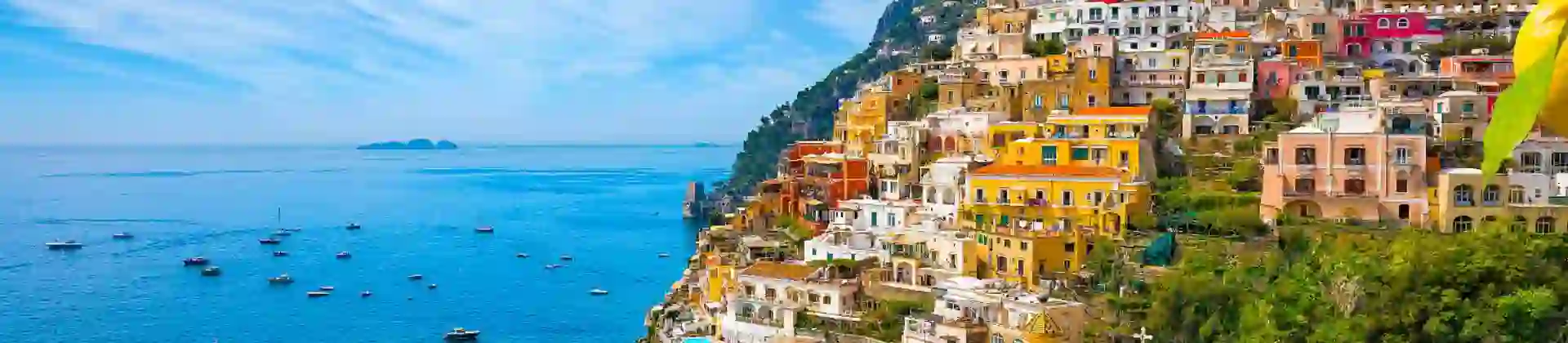 Colourful cliffside village of Positano on the Amalfi Coast, Italy, with pastel-coloured houses cascading down steep hills towards the sparkling blue Mediterranean Sea