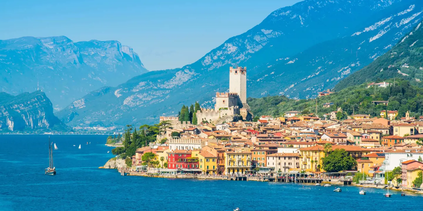 Waterfront in Malcesine, Lake Garda with buildings and mountains in the distance