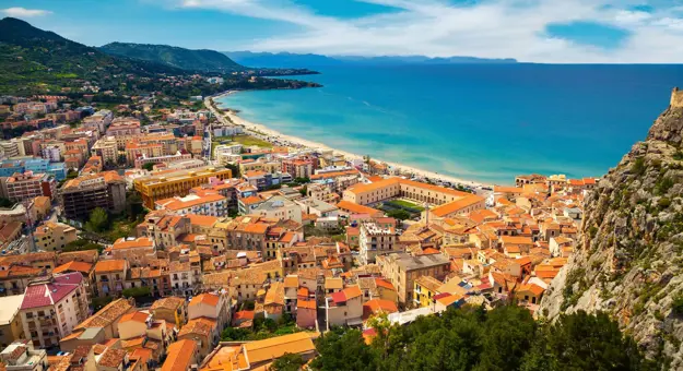 View of the beach and buildings behind it in Cefalu, Sicily, Italy