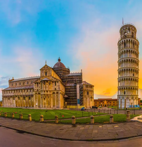 View of the Tower of Pisa and surrounding monuments at sunset 