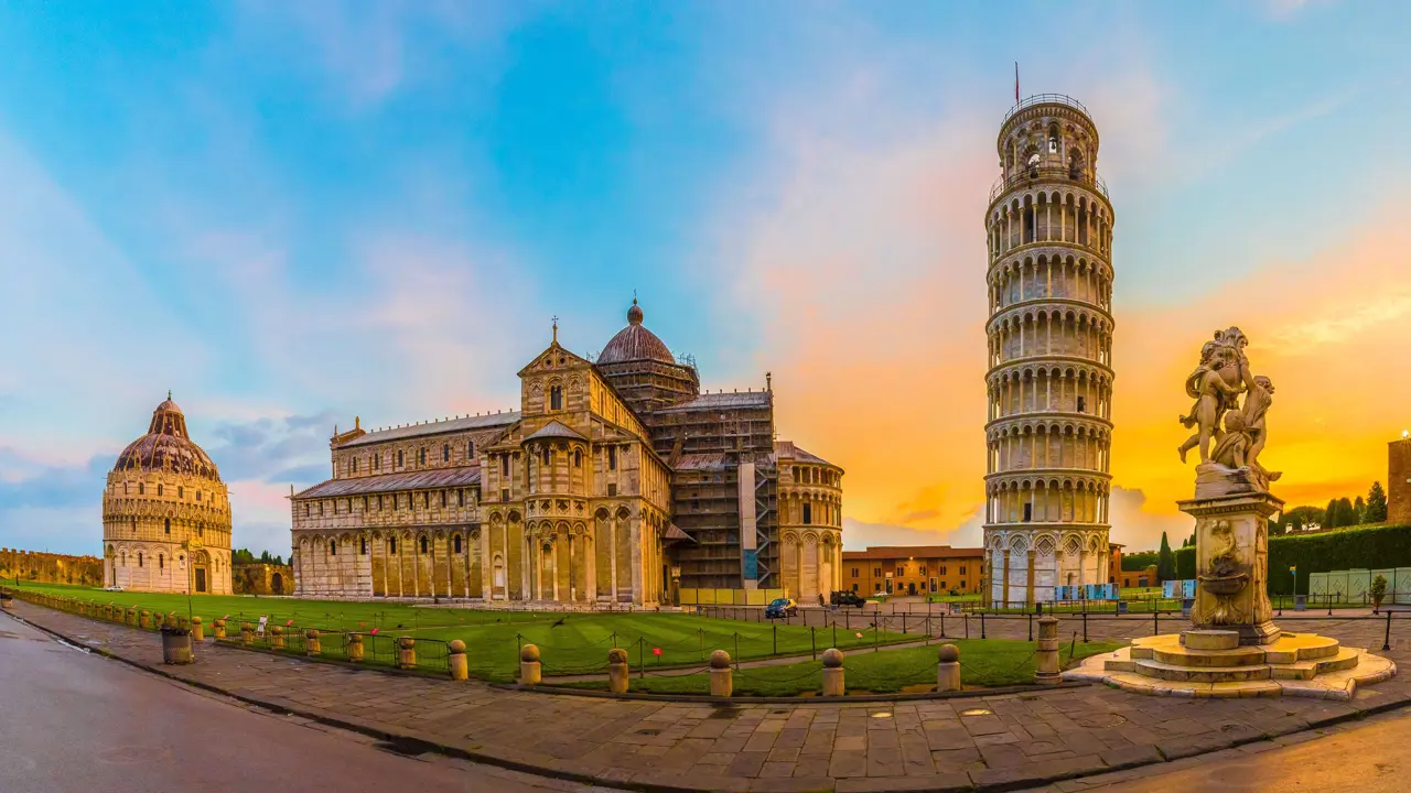 View of the Tower of Pisa and surrounding monuments at sunset 